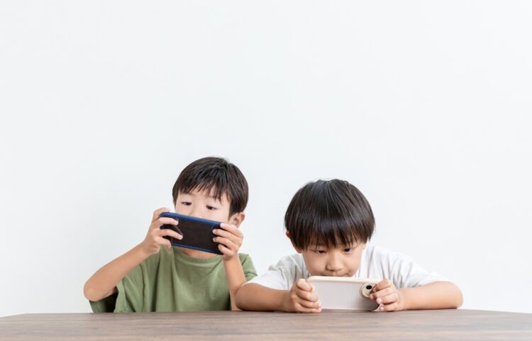子ども2人がスマホでゲームをしている様子